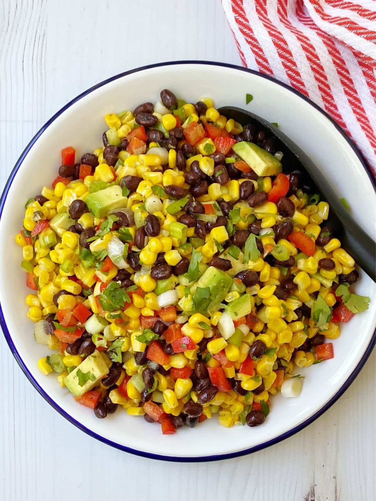 top down shot of corn and black bean salad in a white bowl.