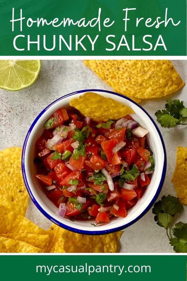 bowl of fresh chunky salsa with tortilla chips surrounding it.