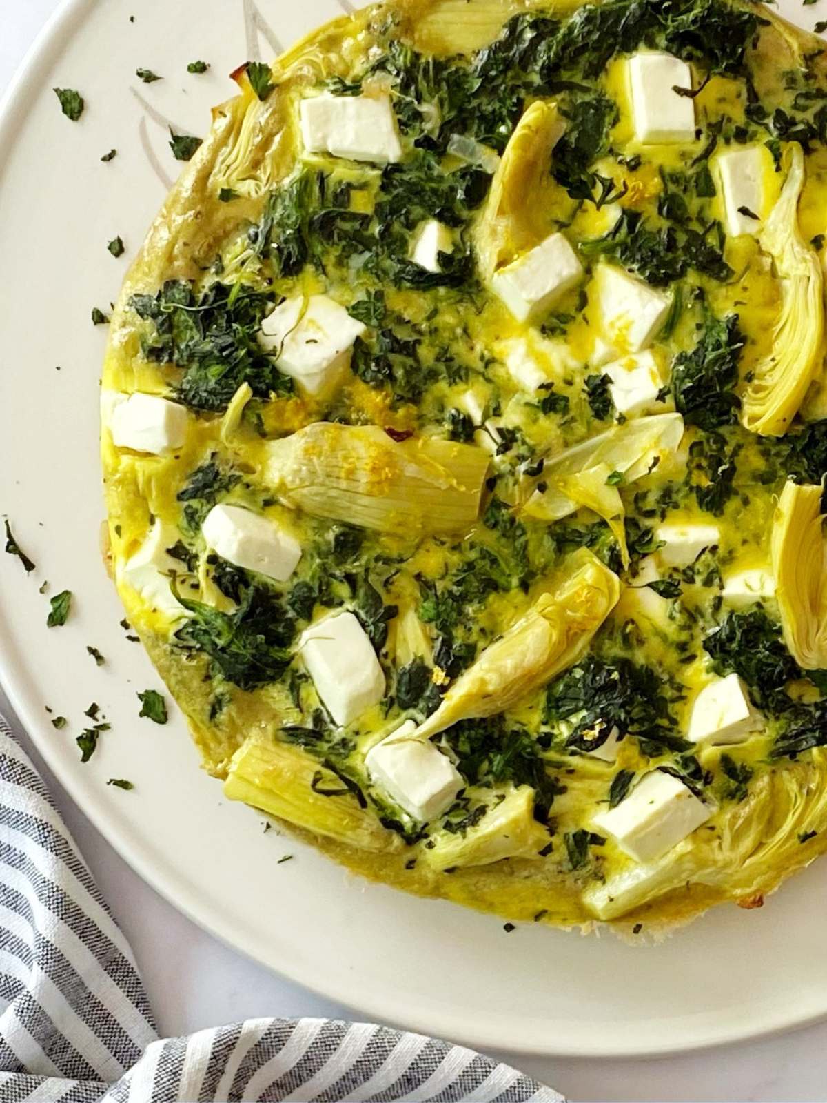Close-up of spinach frittata on a serving platter.