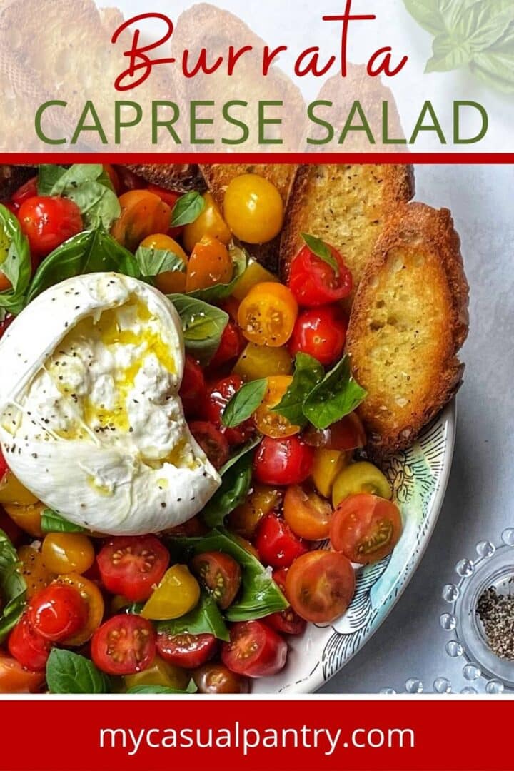 platter of caprese salad with burrata and toasted crostini.