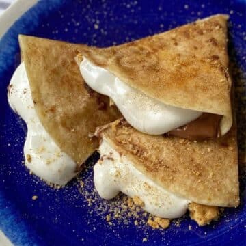 slices of s'mores quesadilla on a blue plate.