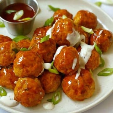 close up of buffalo chicken meatballs on a plate.