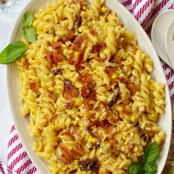 serving platter of corn and bacon pasta.