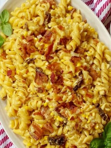 serving platter of corn and bacon pasta.