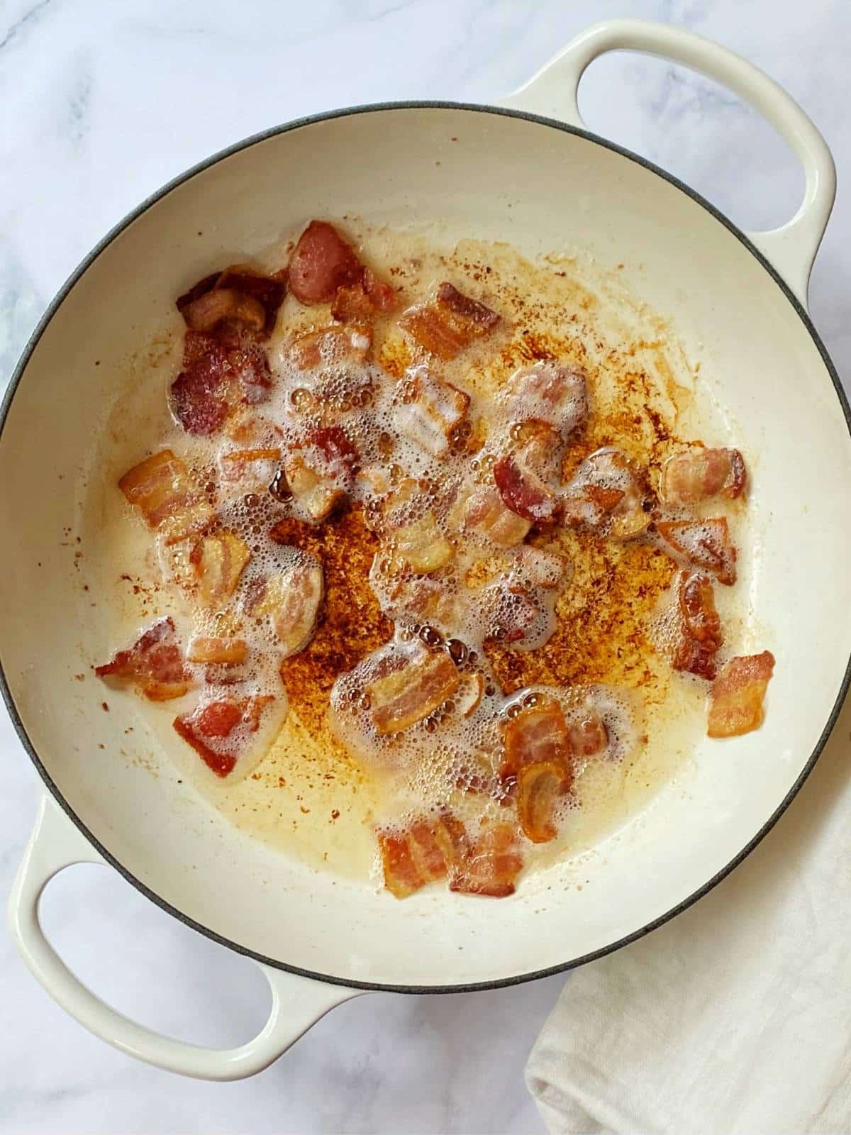 bacon cooking in skillet.