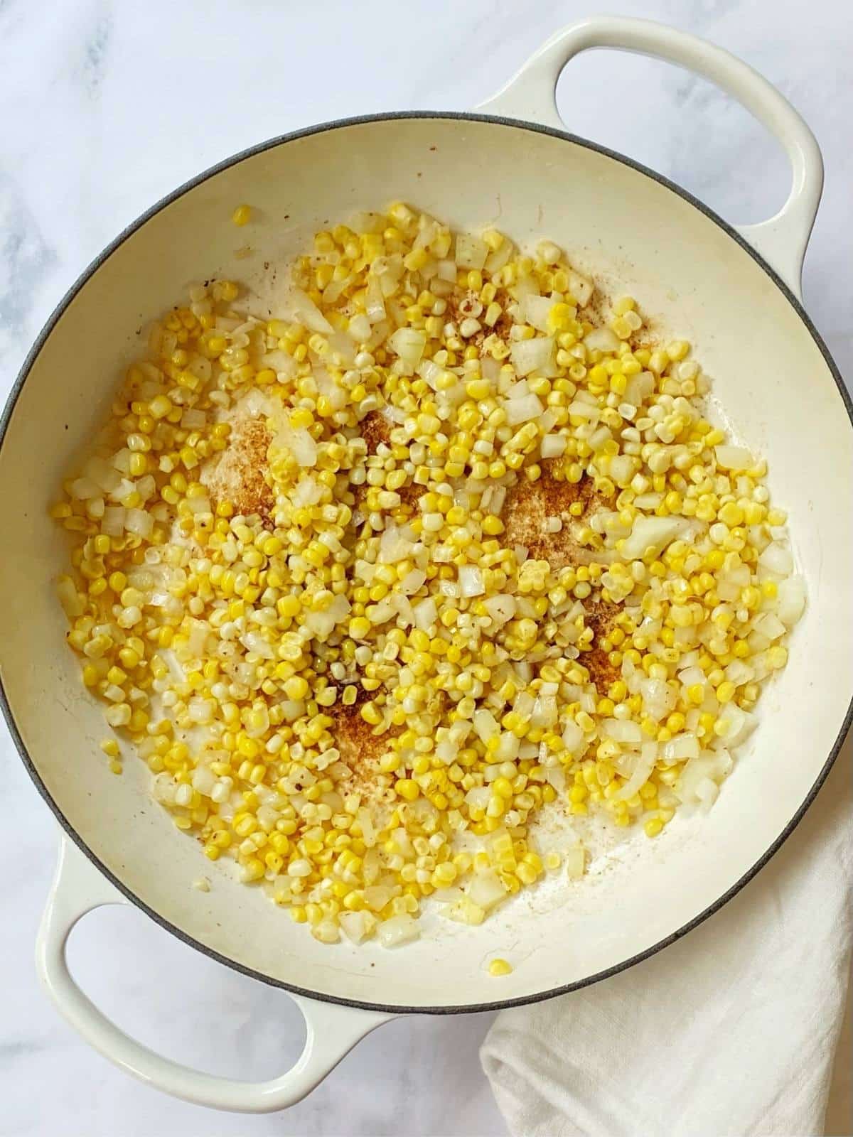 sweet corn and onions cooking in the skillet.