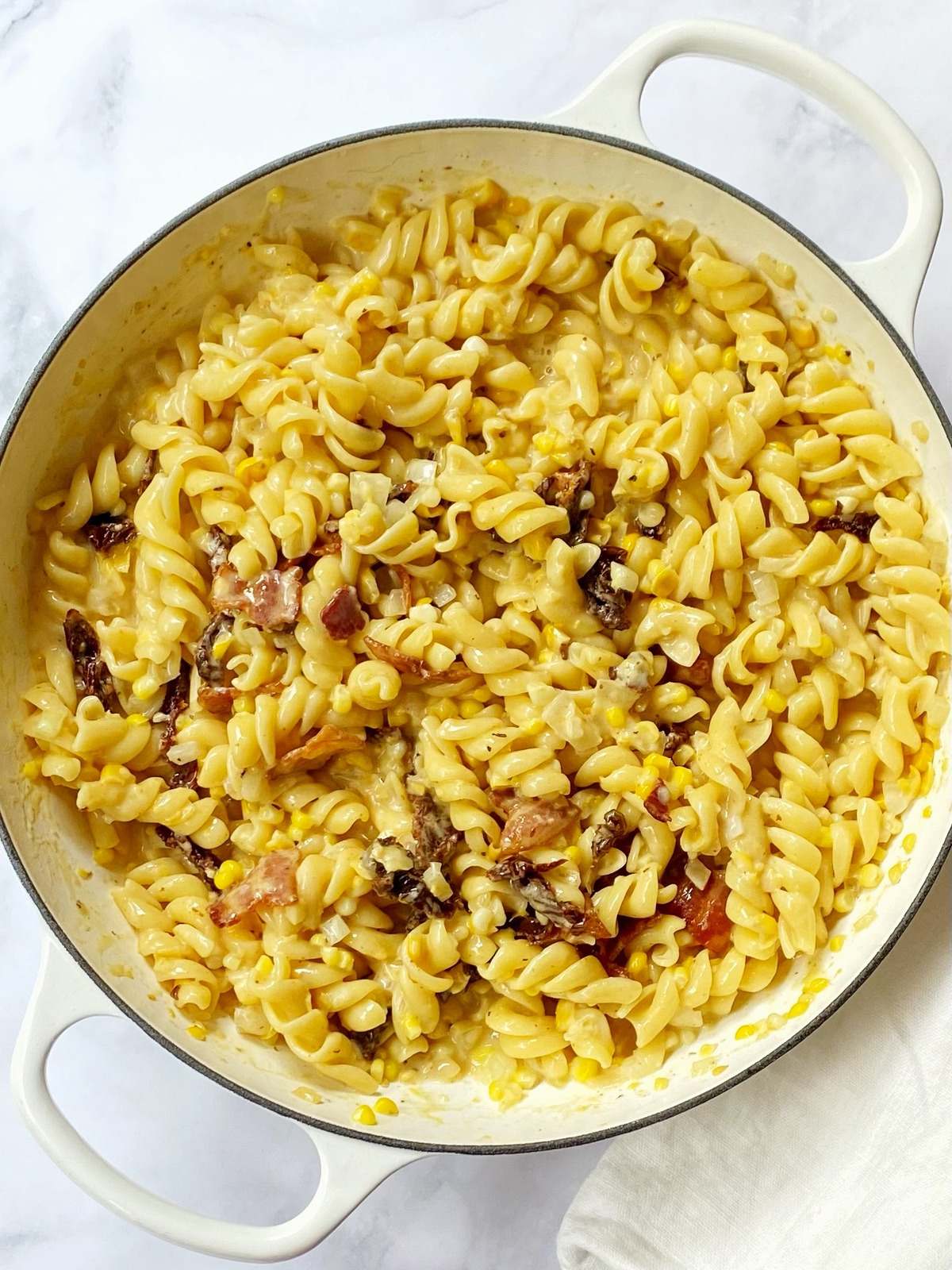 skillet of pasta, corn, bacon, and sun-dried tomatoes.