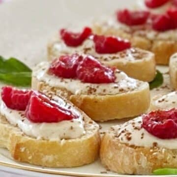 Raspberry crostini on a serving platter.