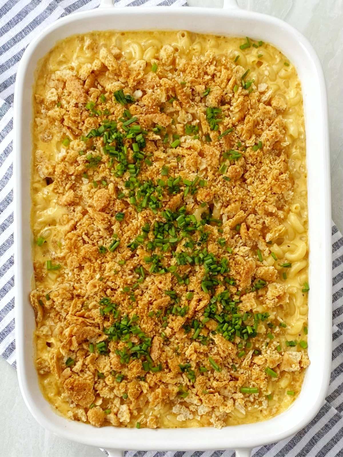 baked mac and cheese garnished with chopped chives.