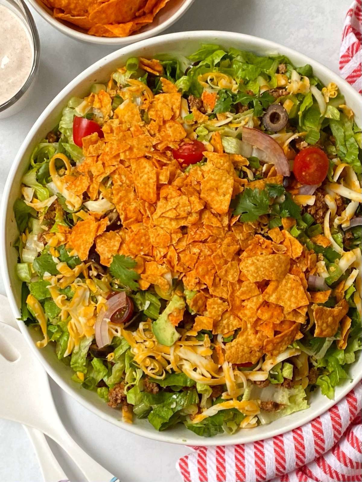 Chopped taco salad tossed and topped with crushed Doritos.