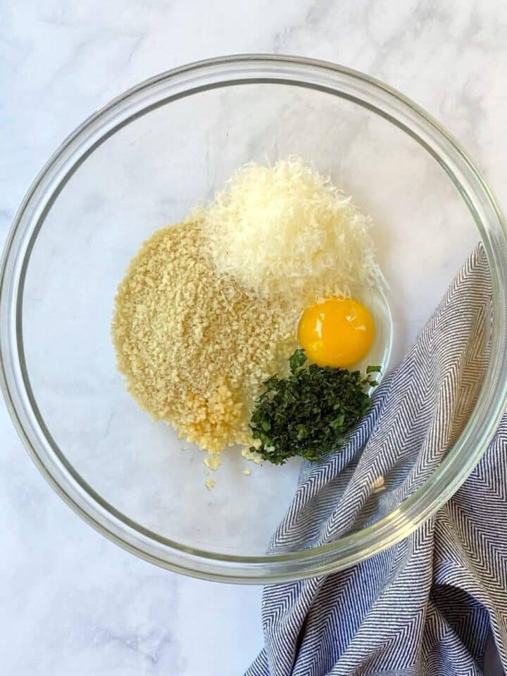 breadcrumbs, cheese, egg, and seasonings in a mixing bowl.