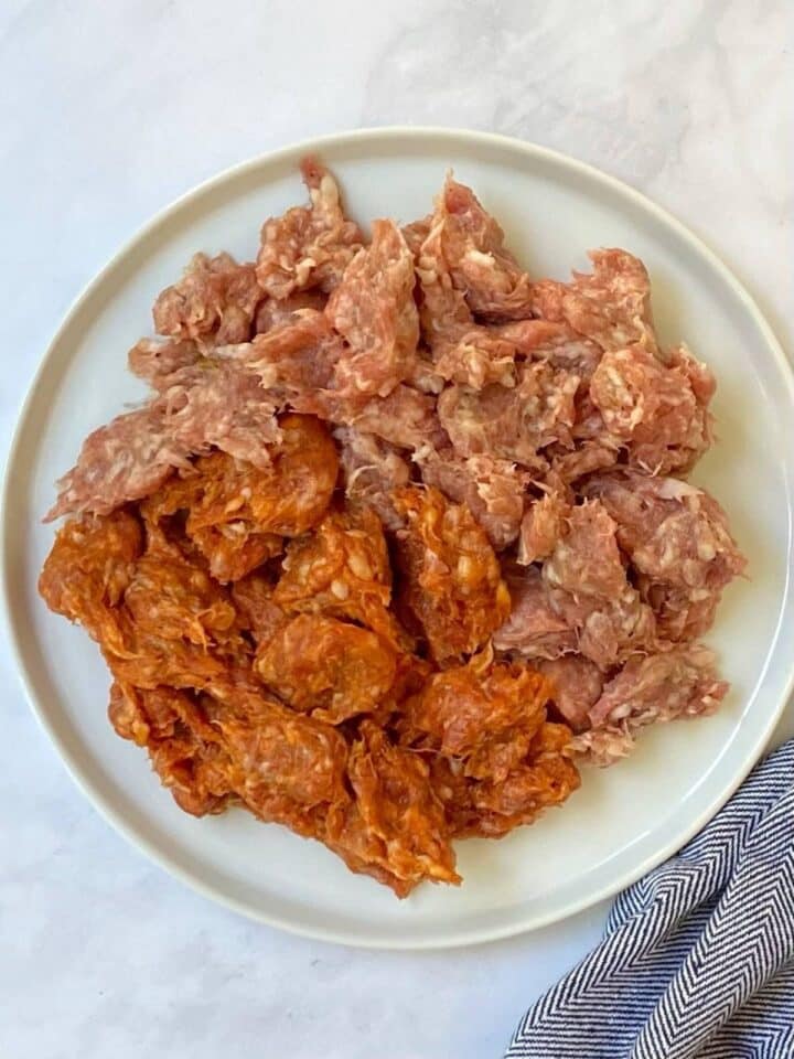 raw crumbled sausage on a plate.