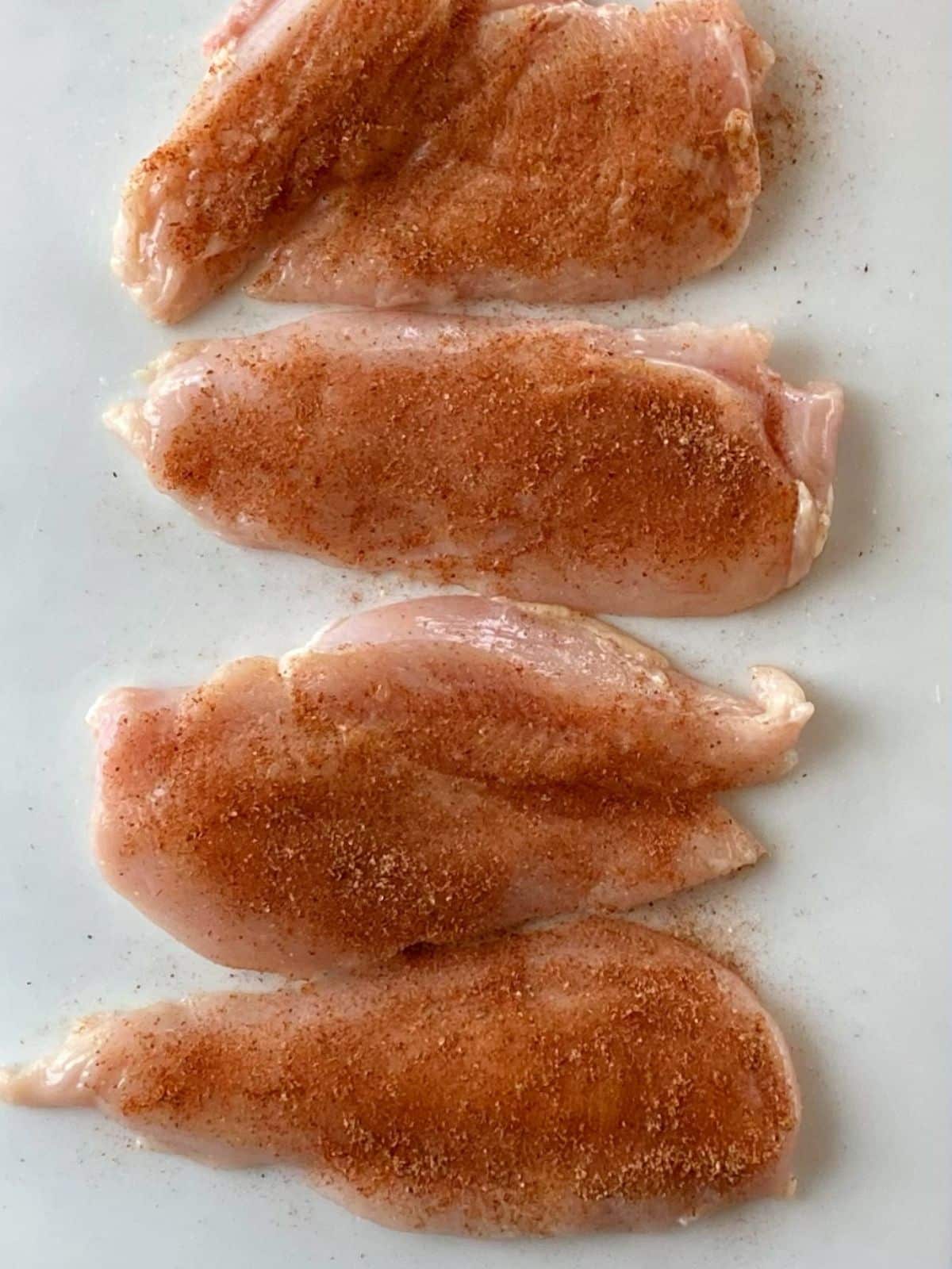 Chicken breasts seasoned with spice mixture.
