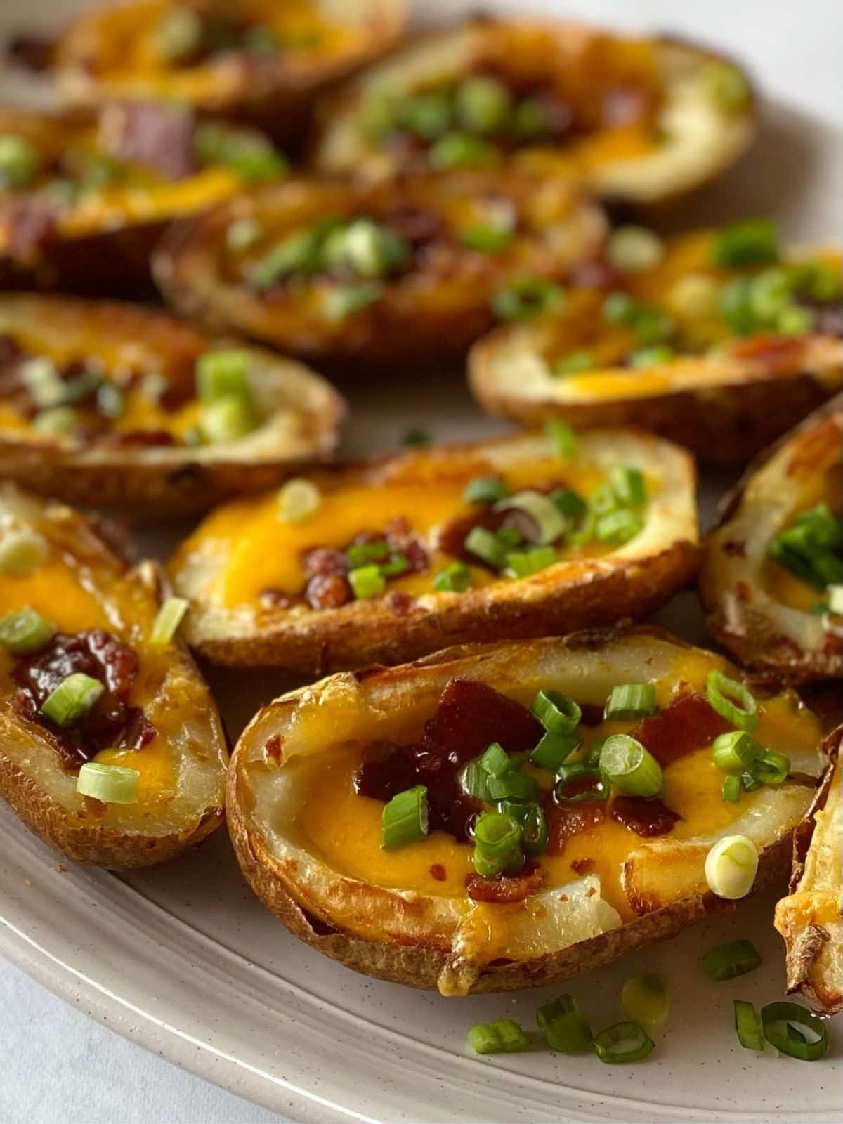 Close up of baked potato skins with cheese and bacon.