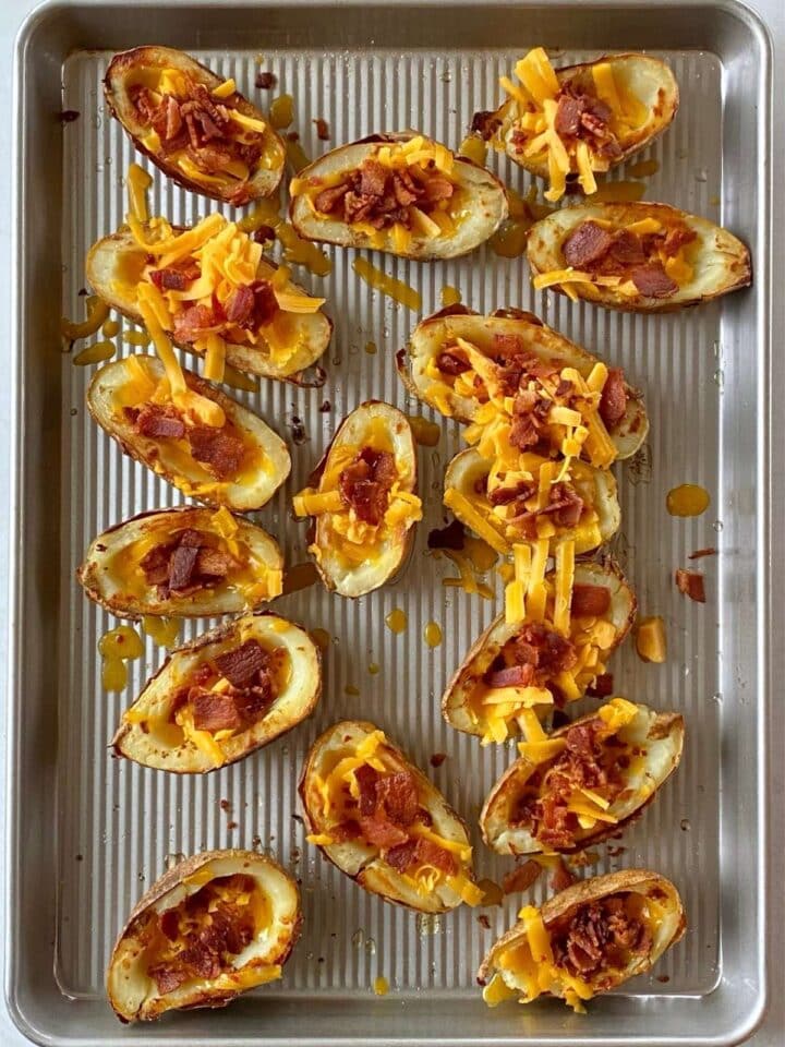 Baked potato shells topped with cheddar cheese and bacon.