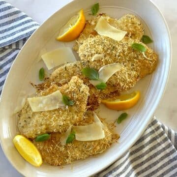 Baked Parmesan crusted chicken on a serving platter.