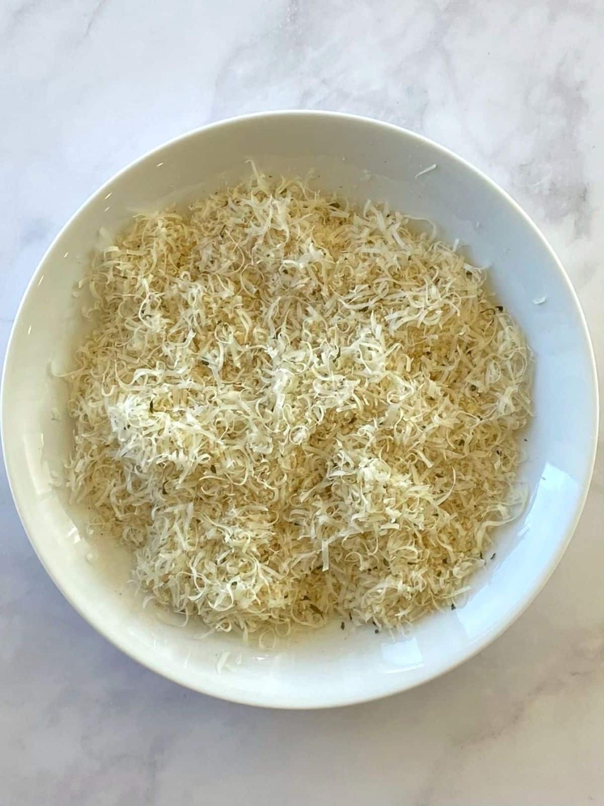 White bowl of Parmesan and panko breading.