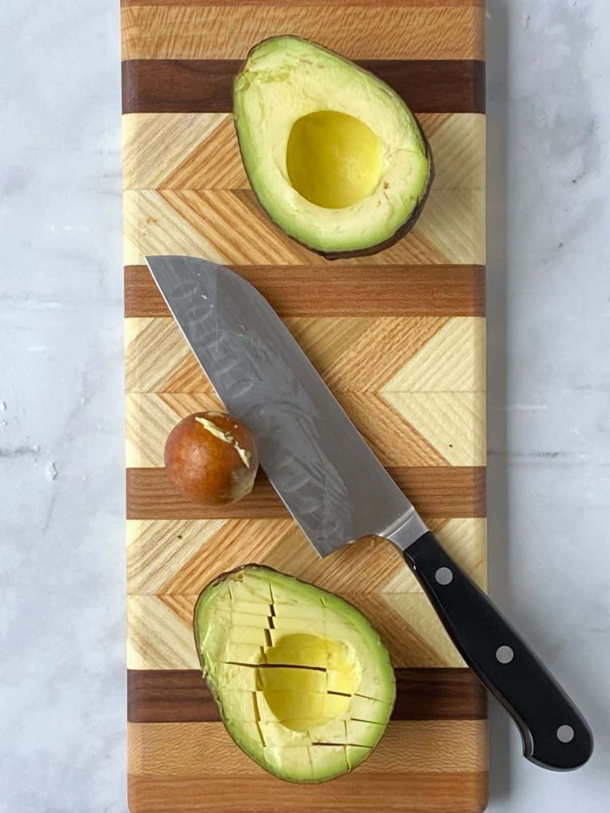 Avocado sliced in half and pit removed.