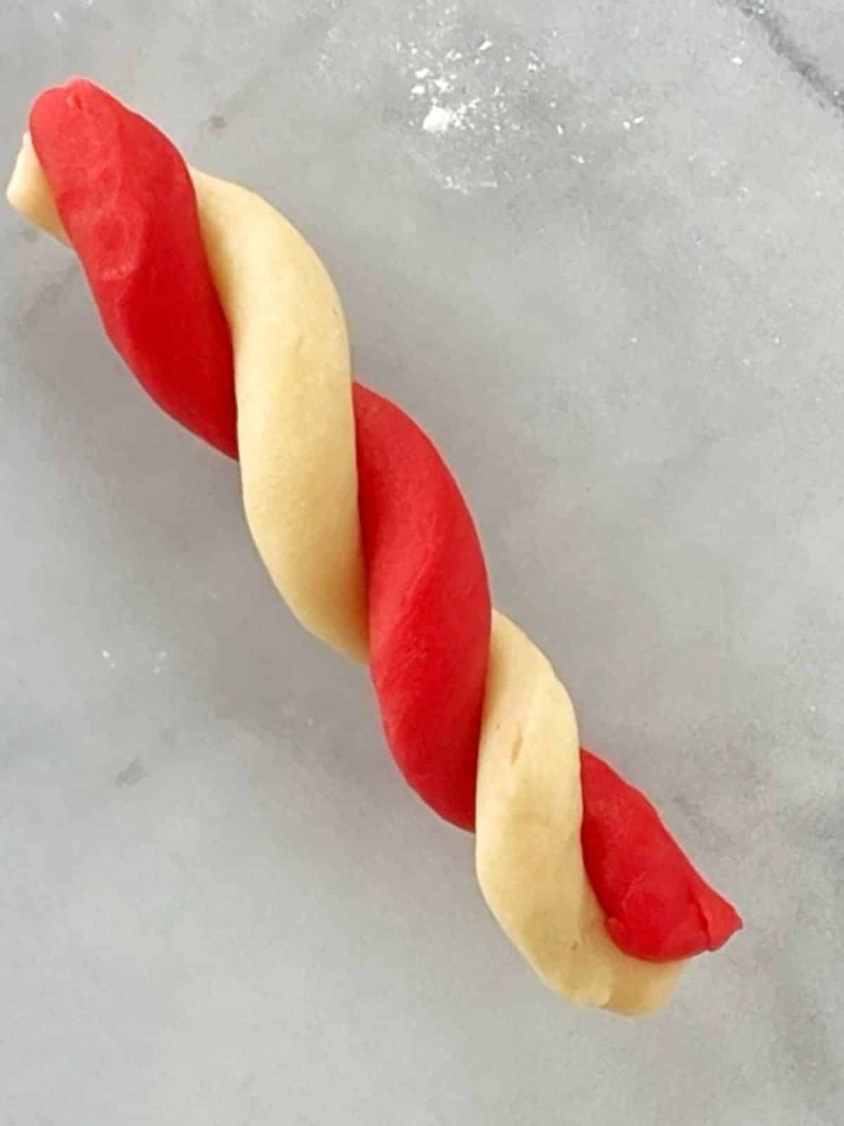 Twisting dough into candy cane shape.