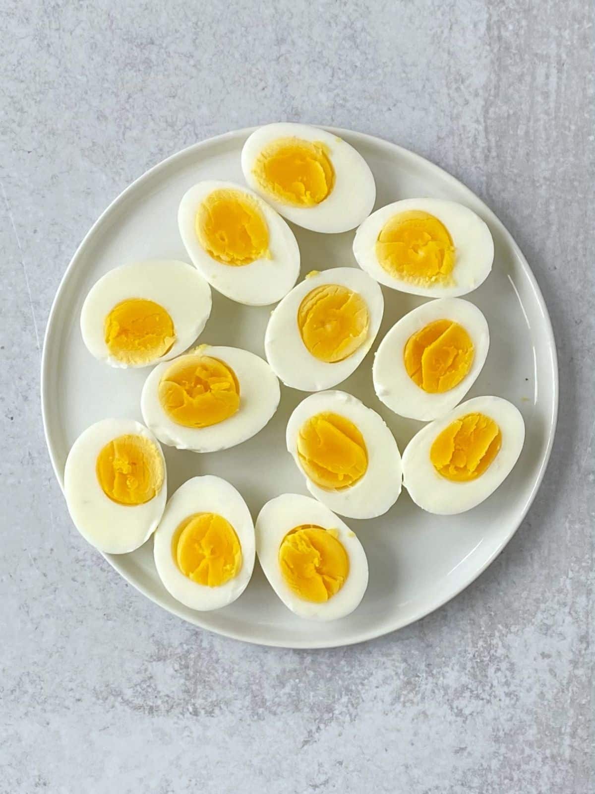 Halved hard-boiled eggs on a plate.
