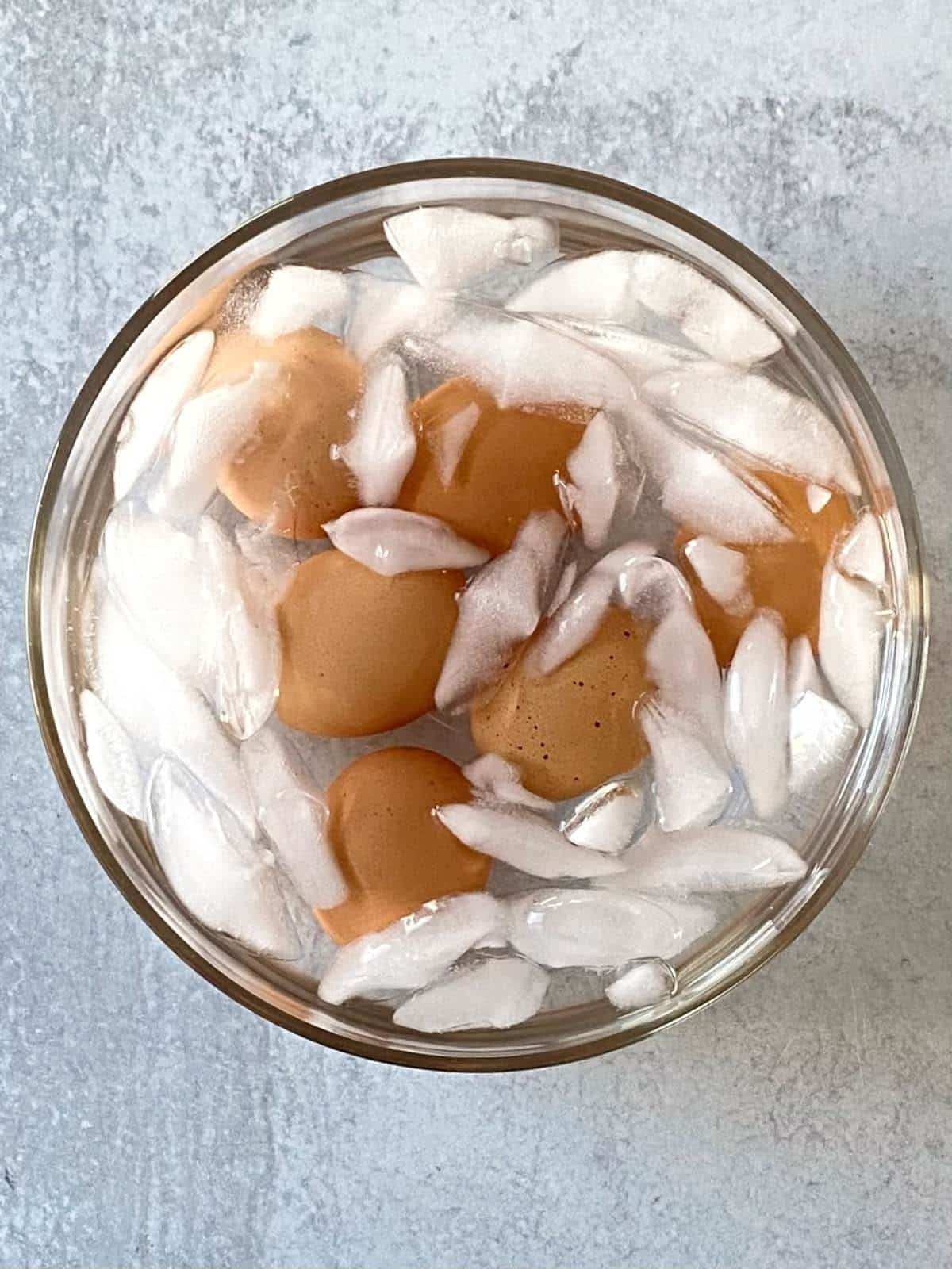 Hard-boiled eggs in a bowl of ice water.