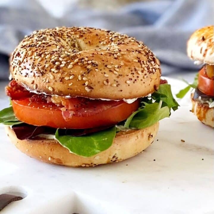 Bagel blt sandwich on a serving board.