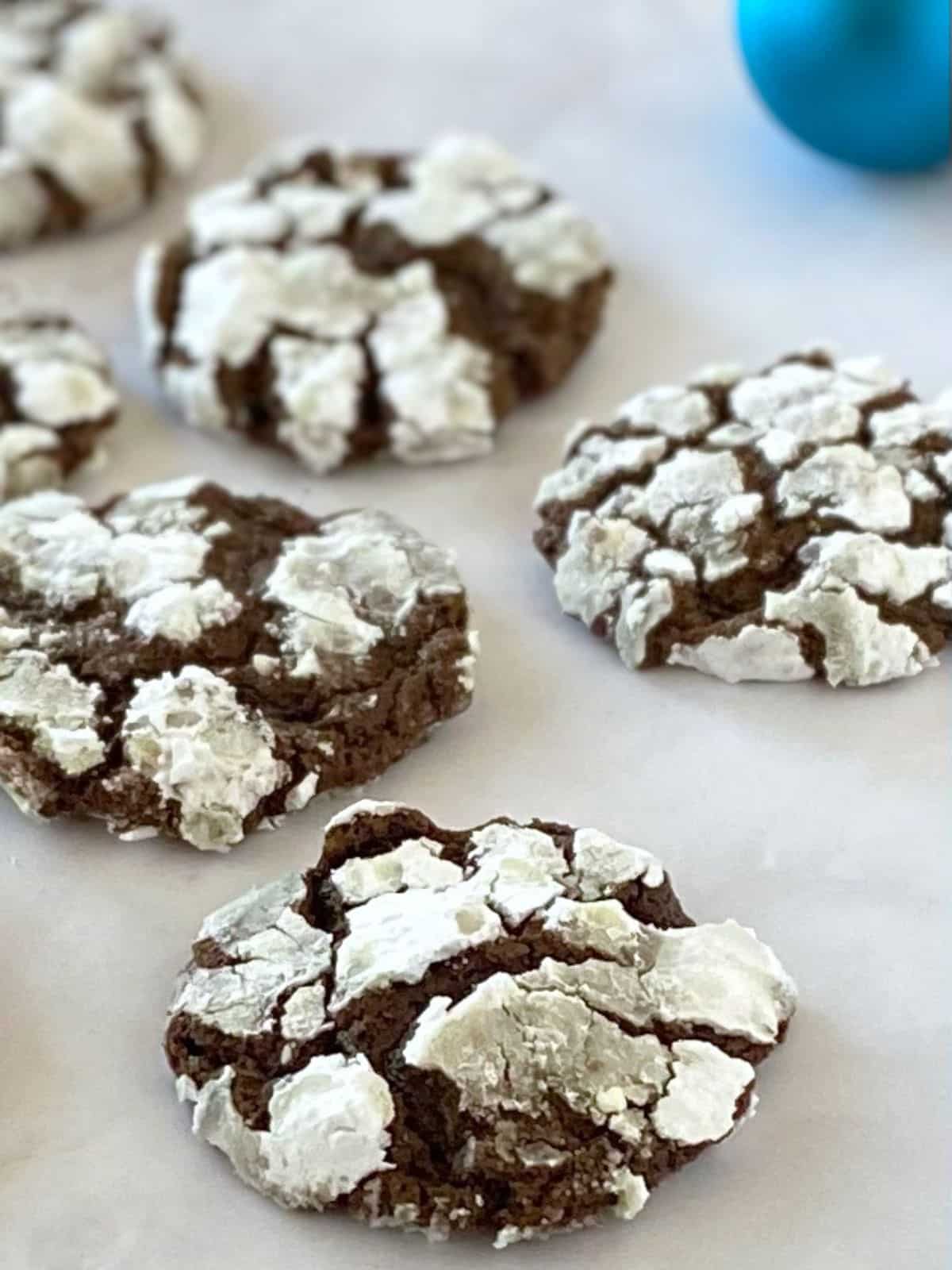 Cookies next to a christmas ornament on the counter.