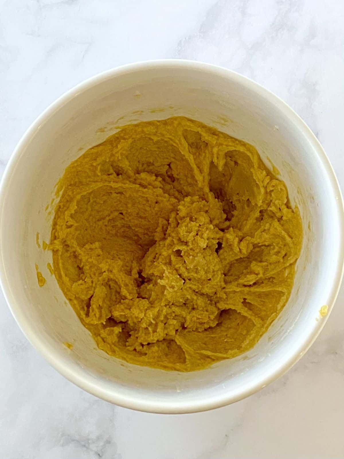 Butter and sugar mixture blended with eggs and vanilla.