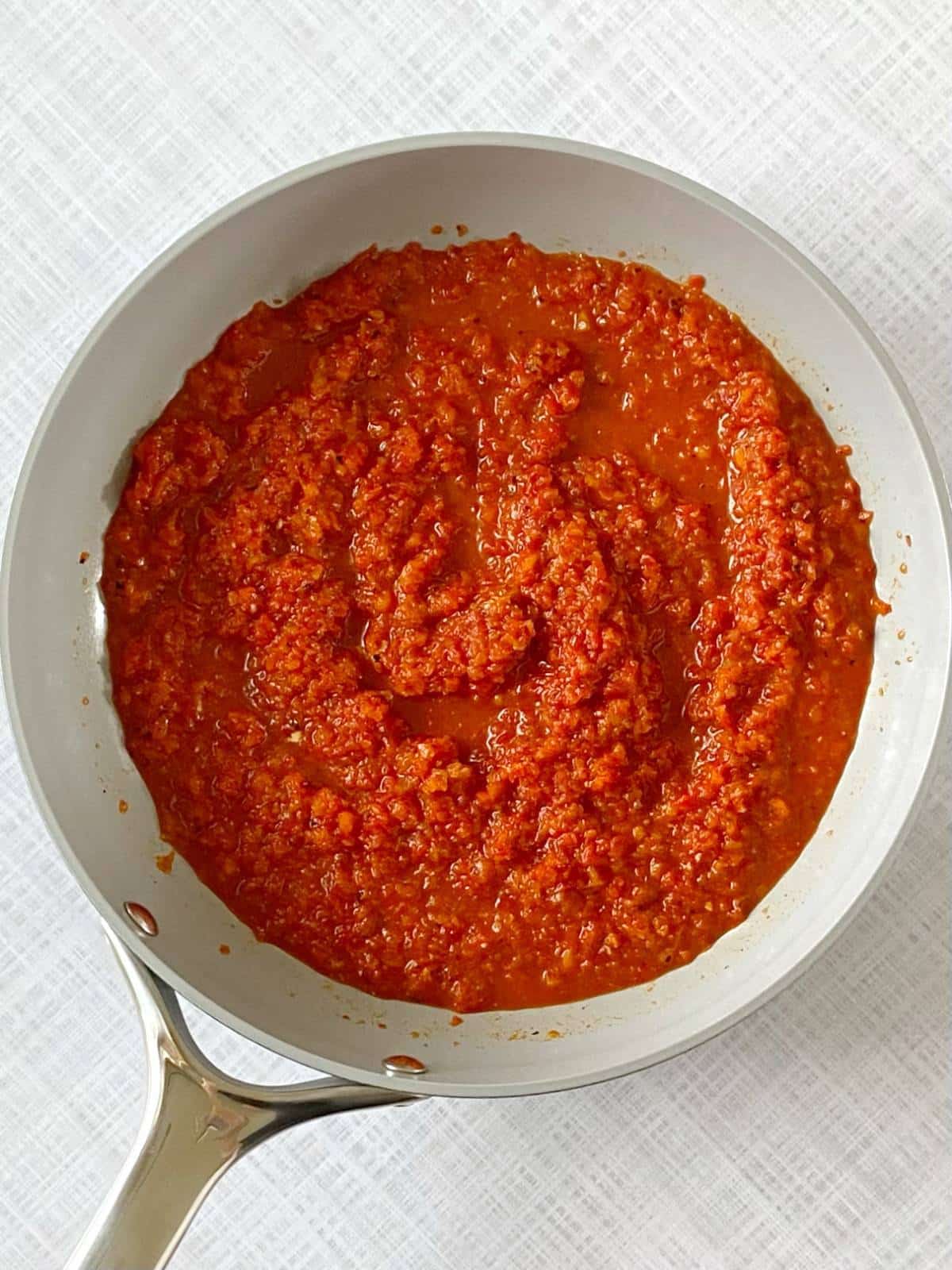 Red pepper sauce in a skillet.