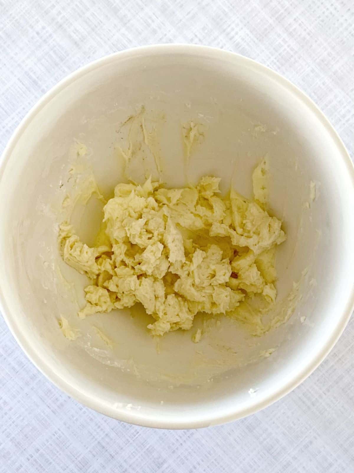 Mascarpone, cream cheese, powdered sugar, and vanilla bean paste whipped together in a bowl.