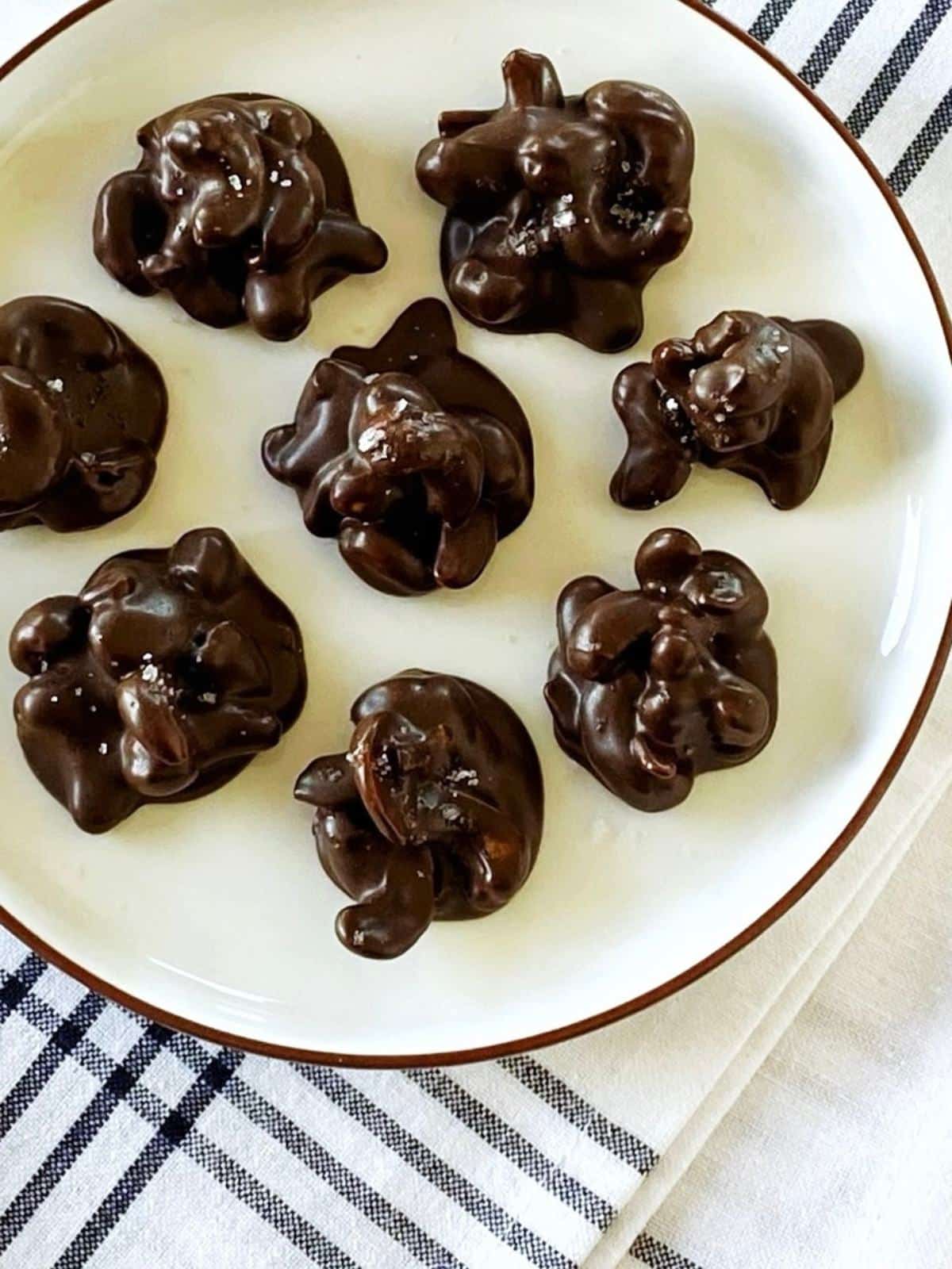 Chocolate nut clusters arranged on a plate.