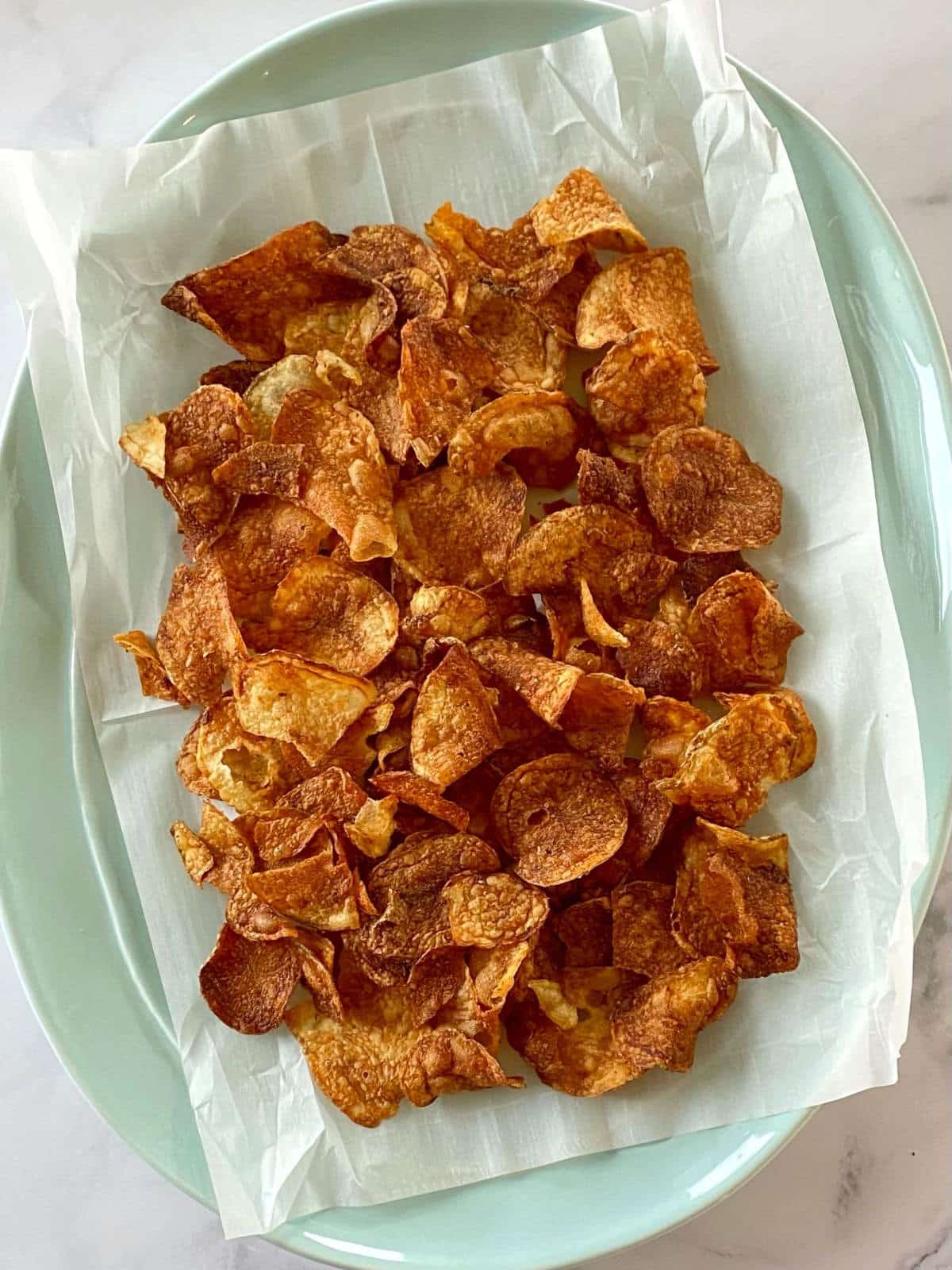 Potato chips on a serving platter.