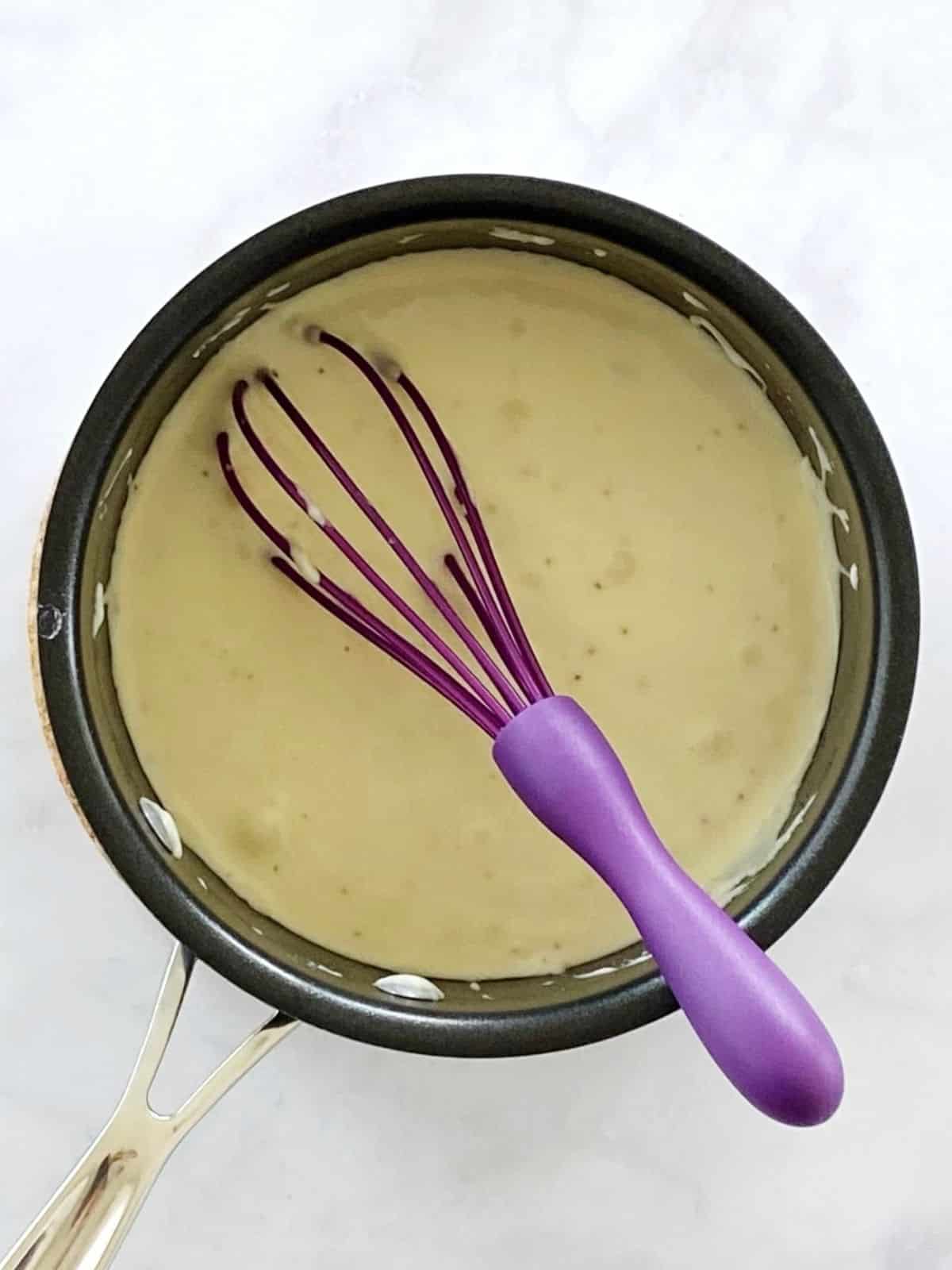 Cheese sauce in a saucepan.