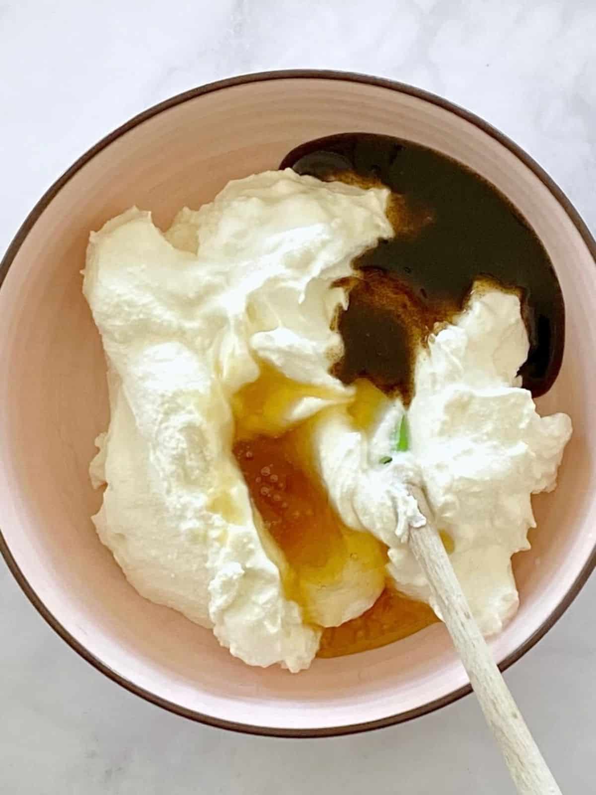 Ricotta, honey, and vanilla bean paste in a bowl.