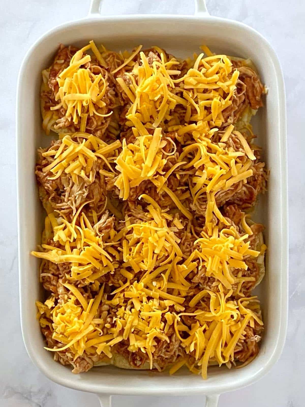 Assembed slider rolls in a baking dish.