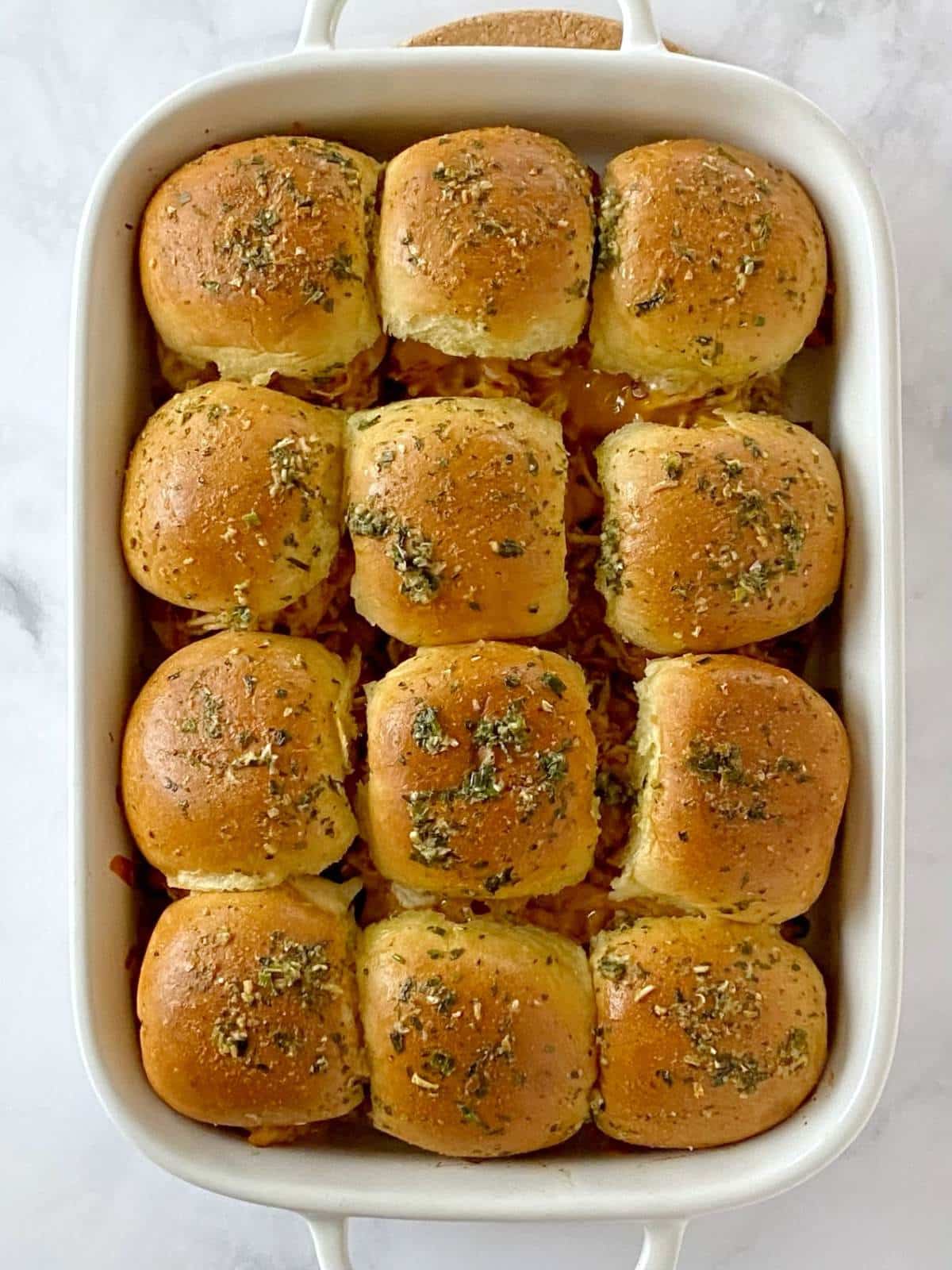Baked sliders in a baking dish.