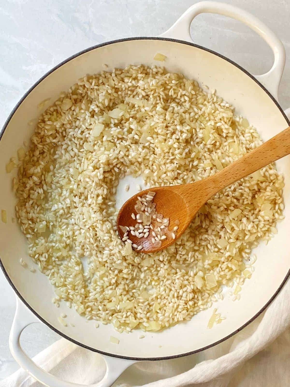 Toasting risotto in a skillet.