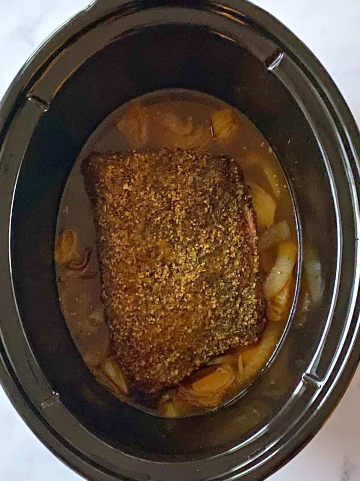 Cooked brisket in slow cooker.