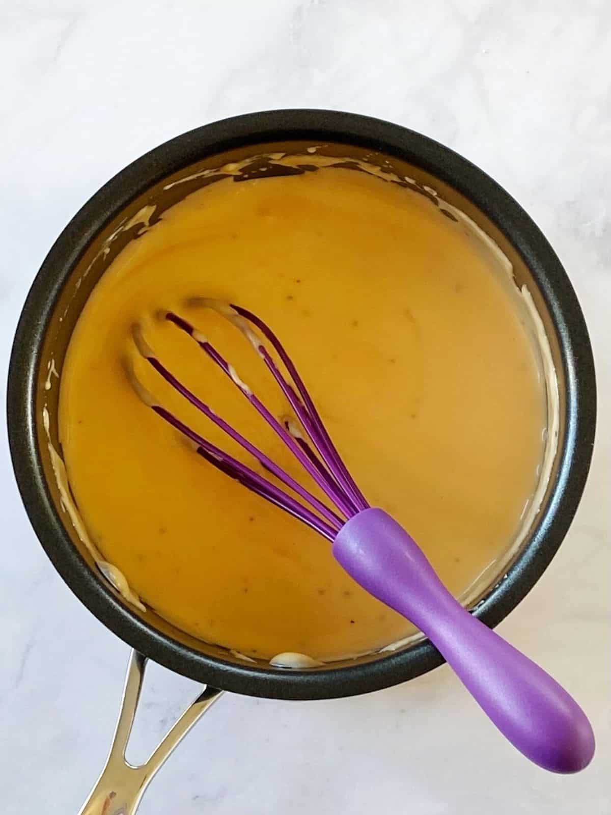 Cheese sauce in a saucepan.