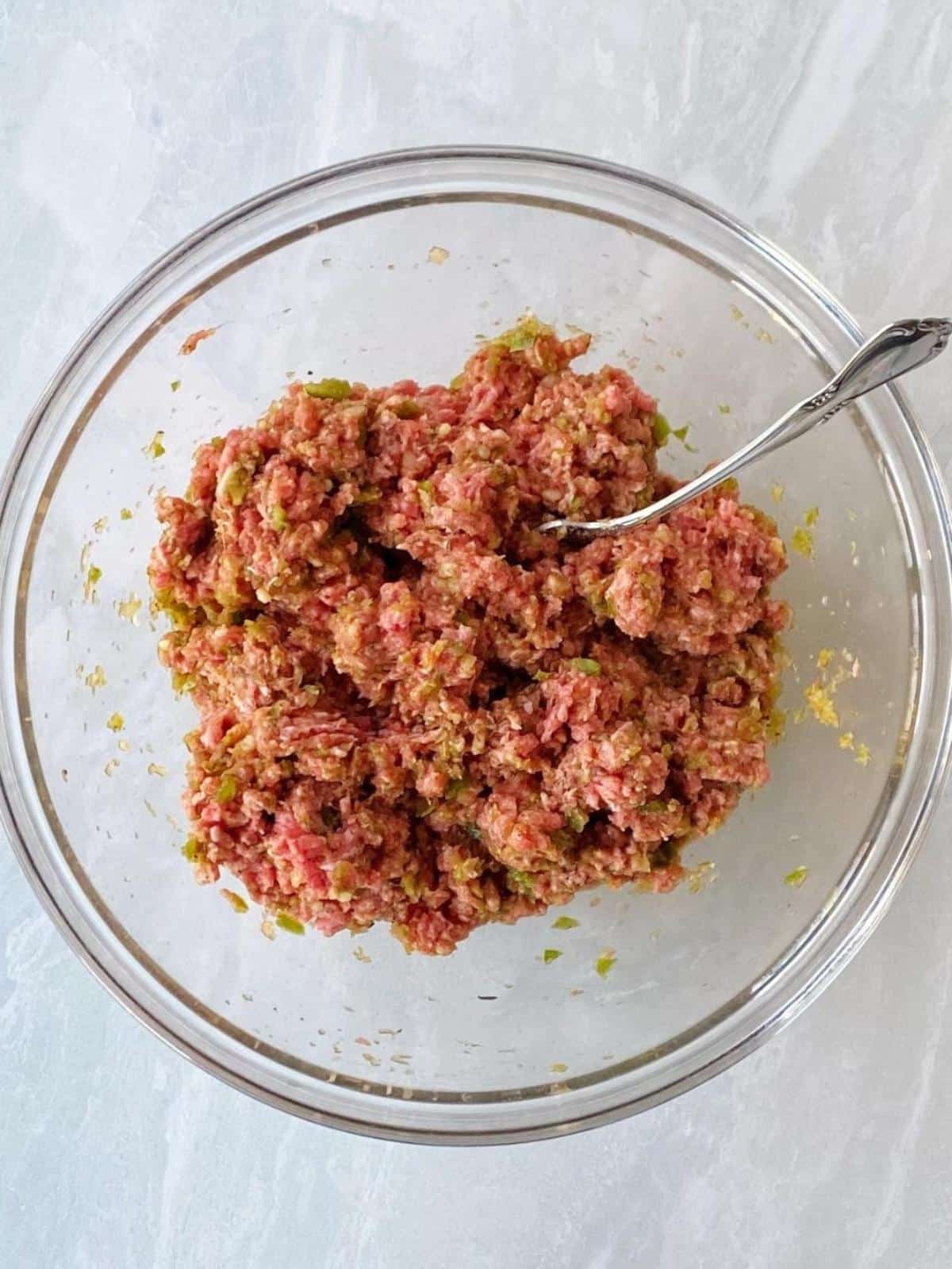 Meatloaf mixture stirred together in a mixing bowl.
