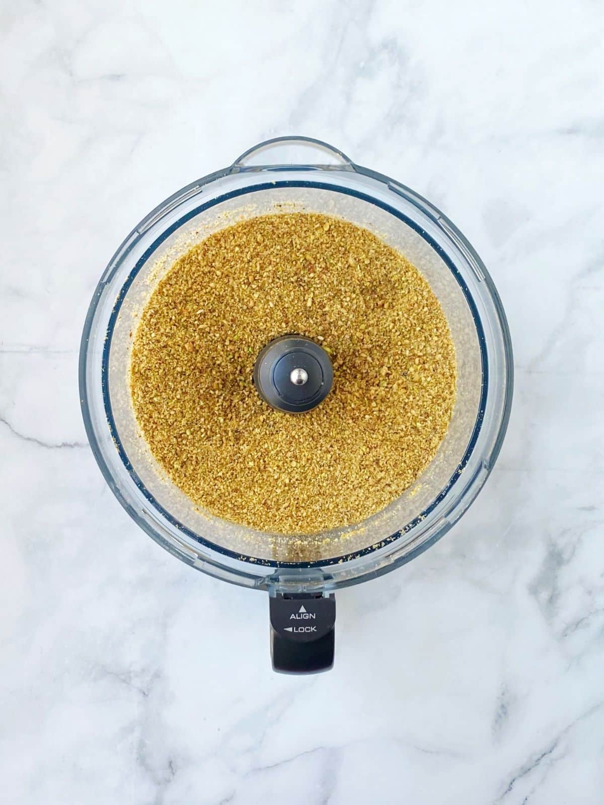 Chopped nuts in a food processor bowl.