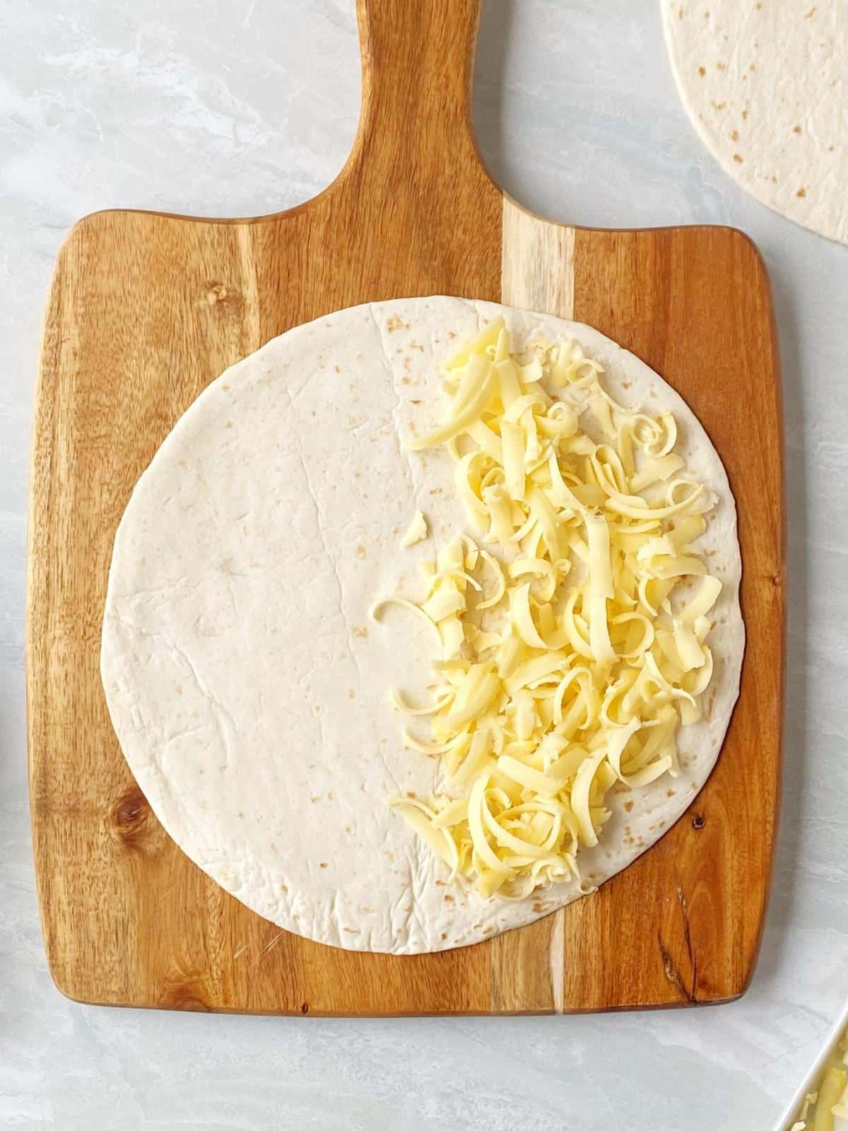 Tortilla topped with cheese.