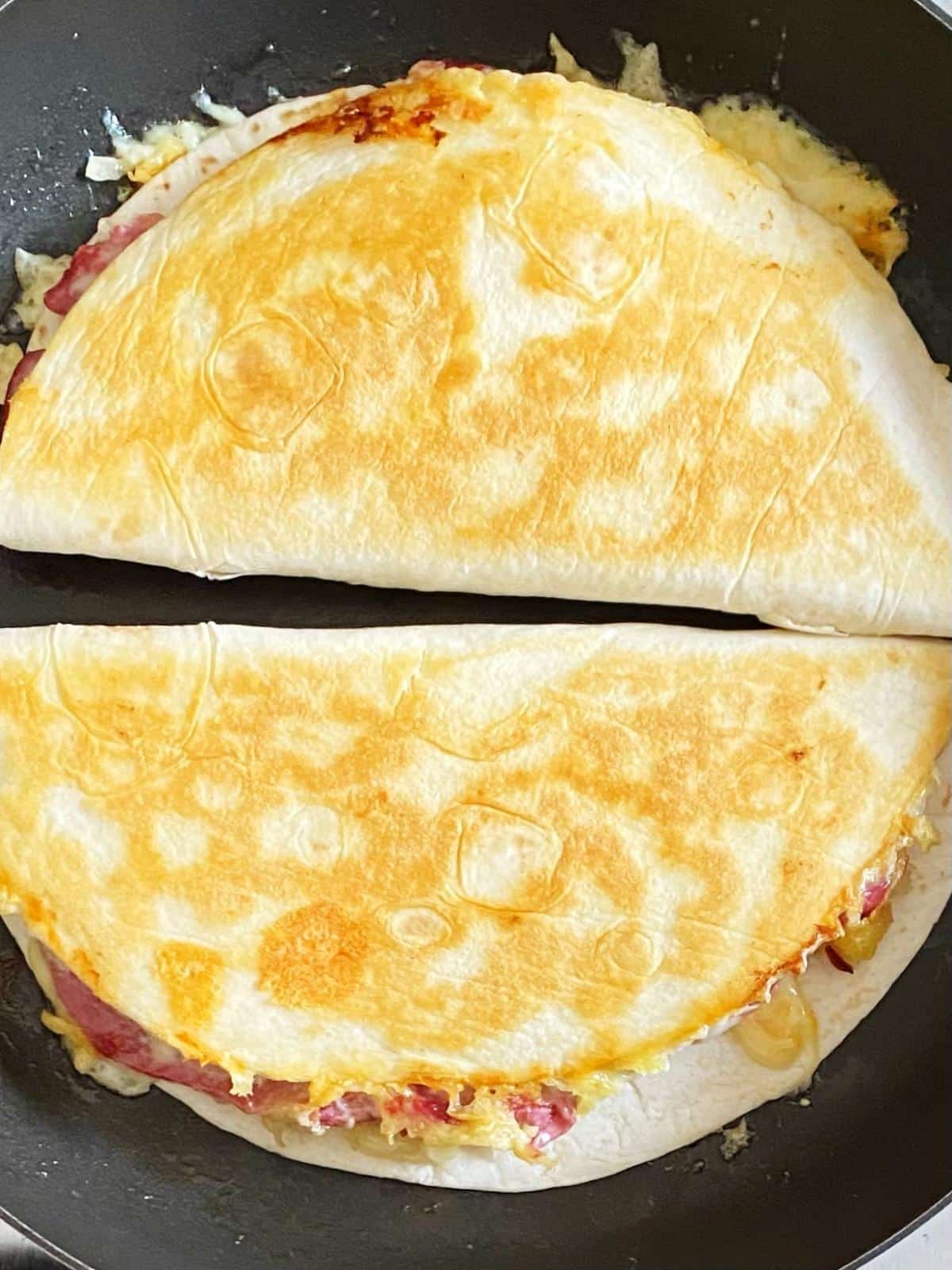Browning the second side of the quesadillas in a skillet.