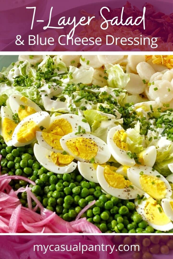Salad ingredients layered on a platter and garnished with chives.
