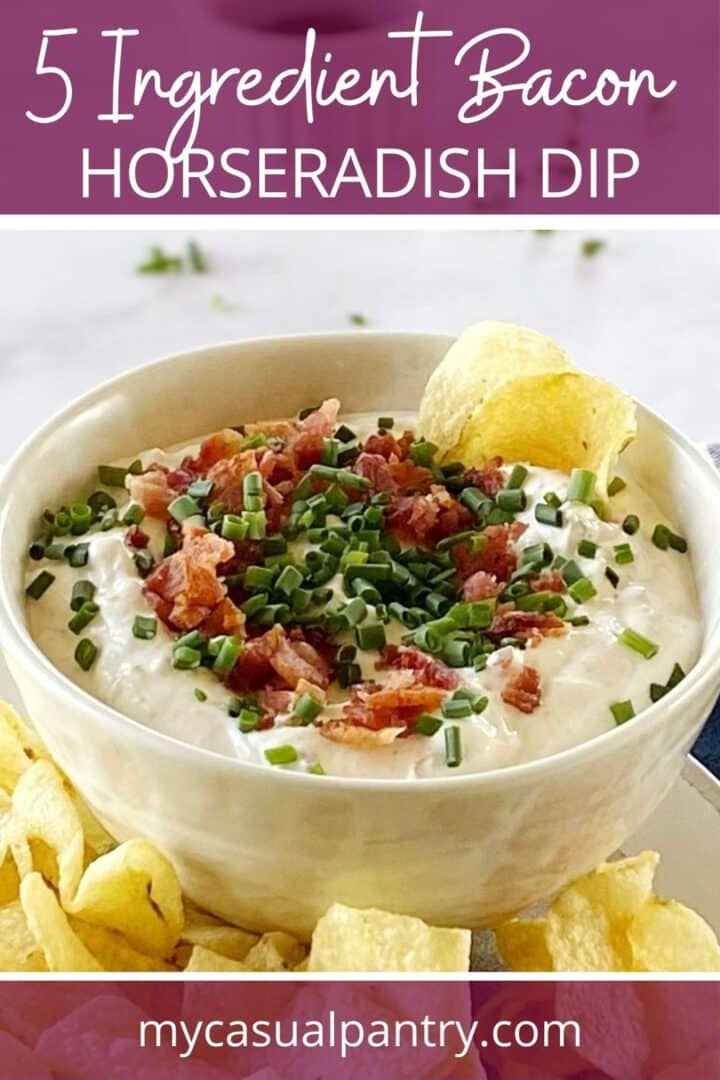 Bowl of dip with chips garnished with bacon and chives.
