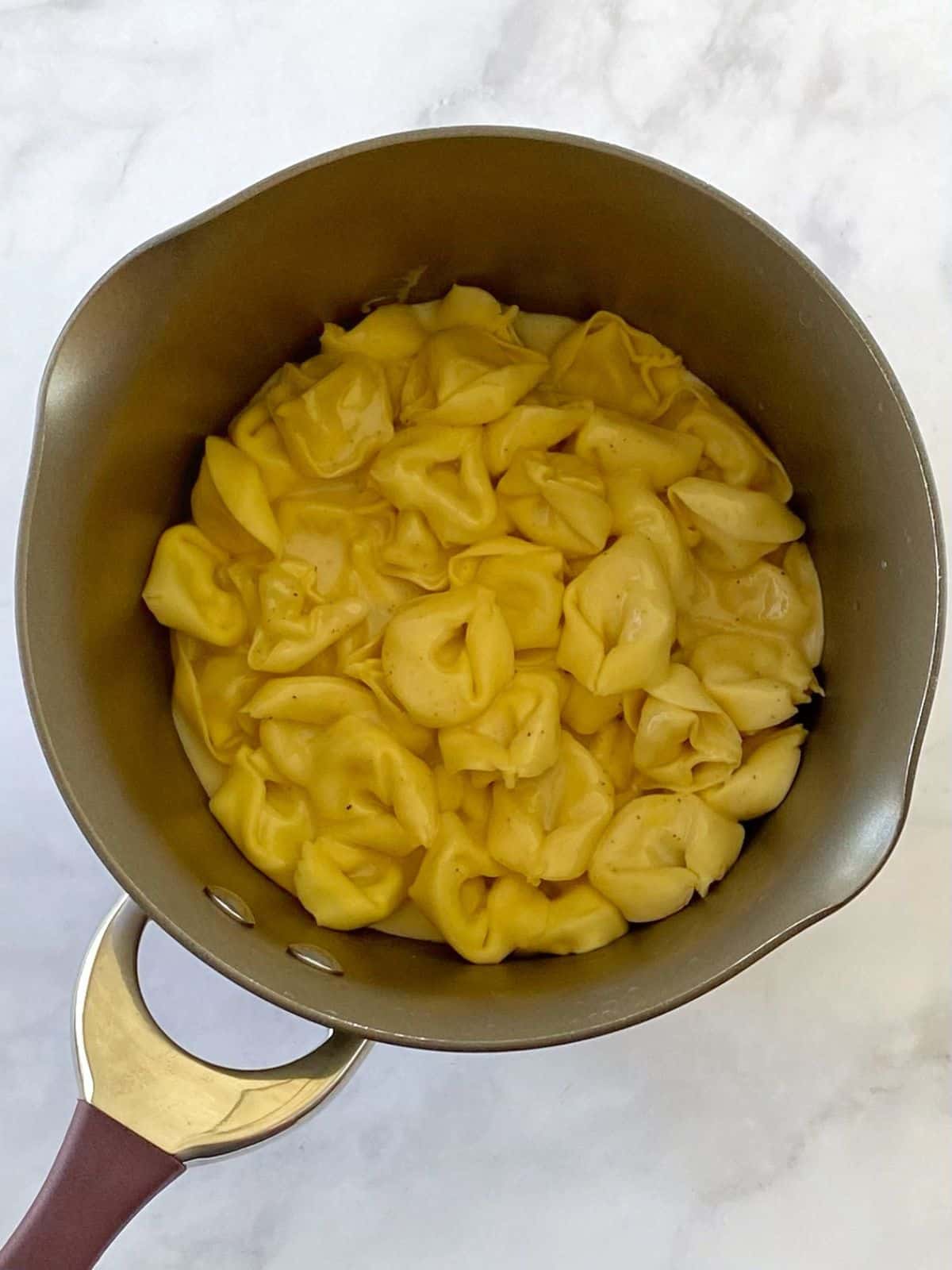 Cooked tortellini in a pan.