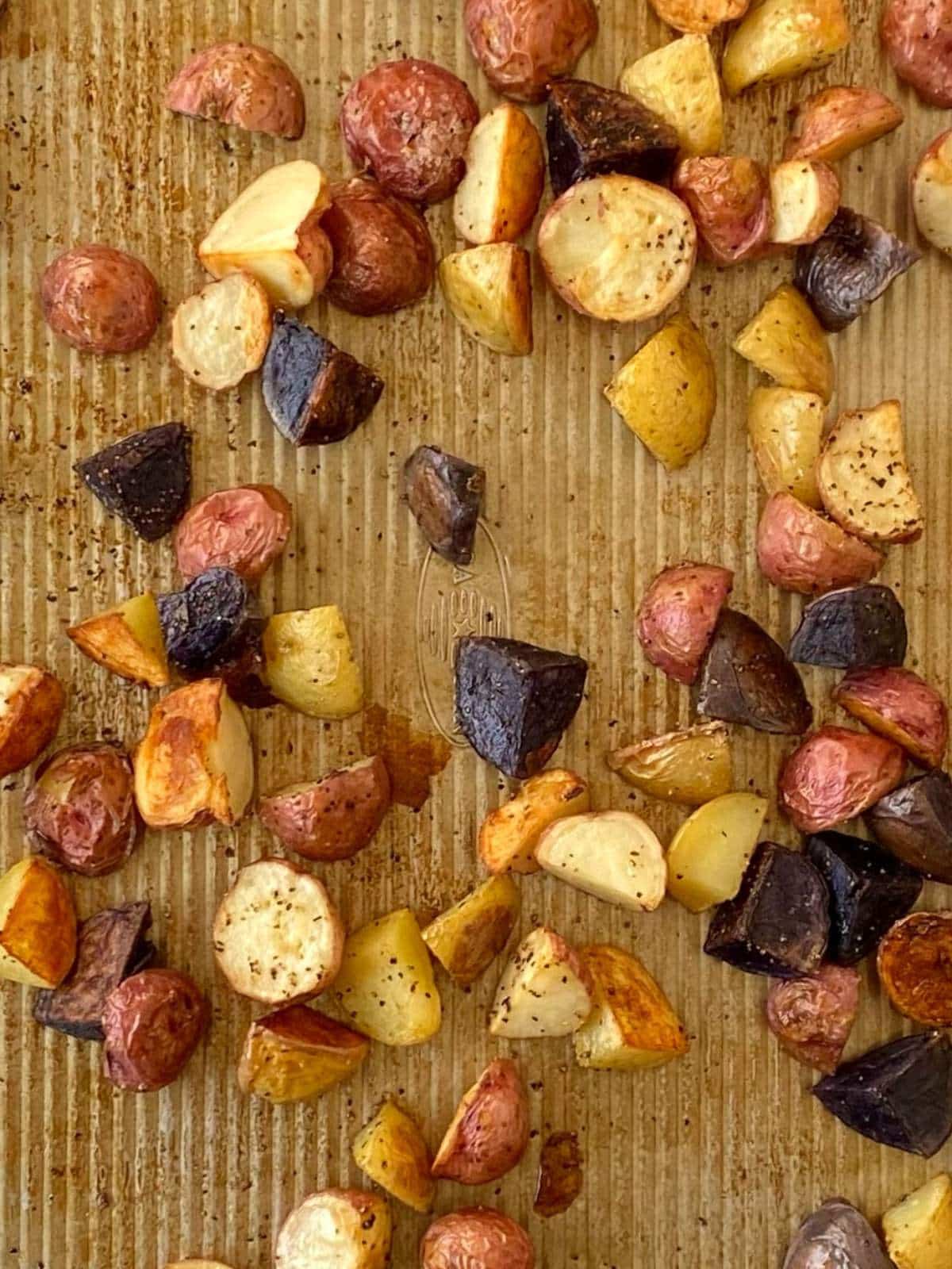Roasted potatoes on a sheet pan.