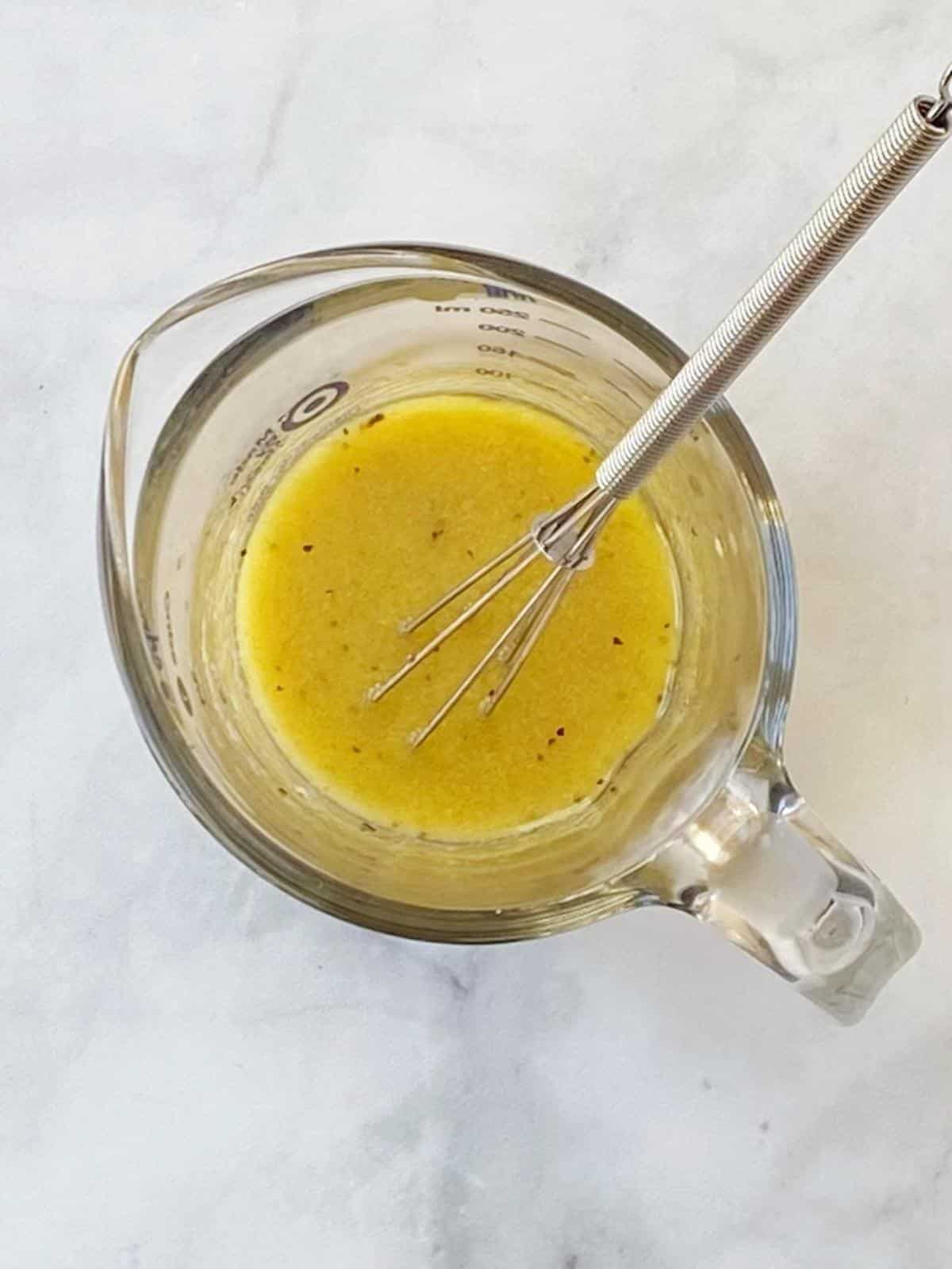 Mustard vinaigrette in a pitcher.