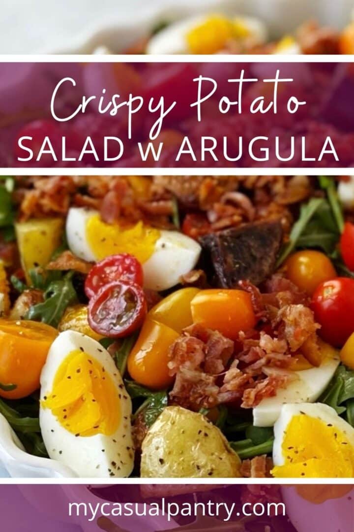 Potato and arugula salad in a white serving dish.