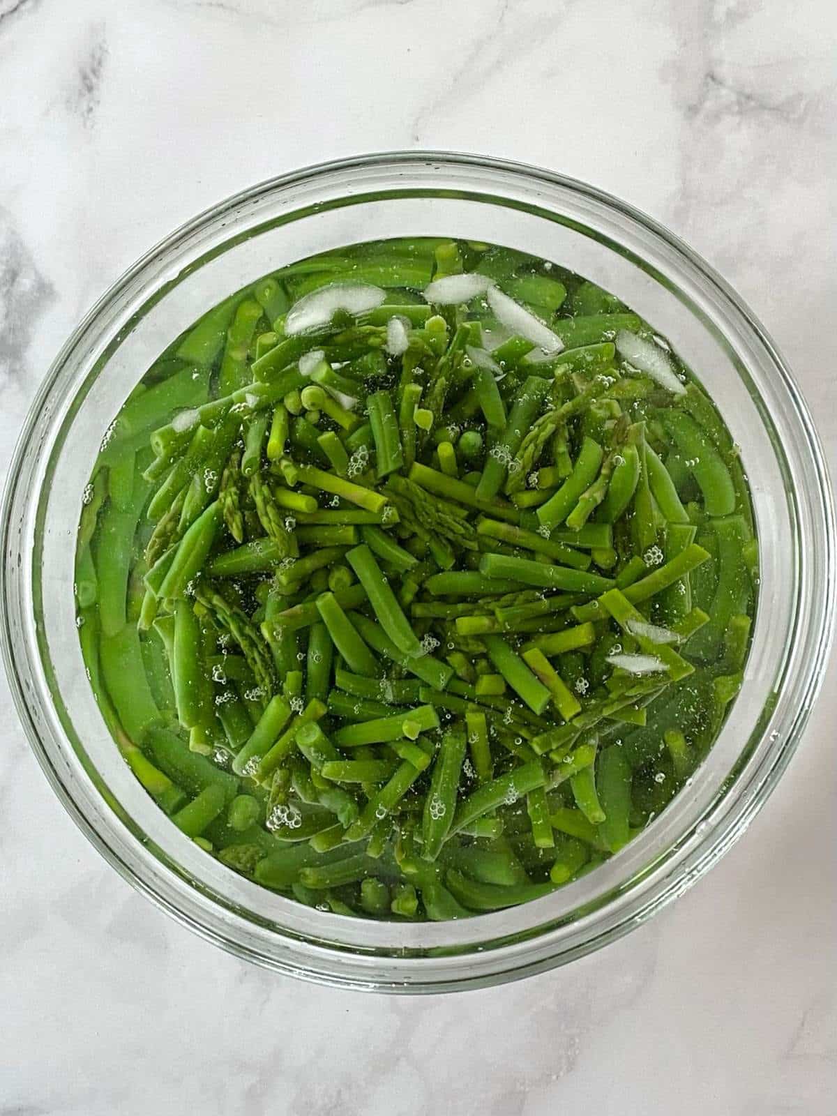 Veggies in a bowl of ice water.
